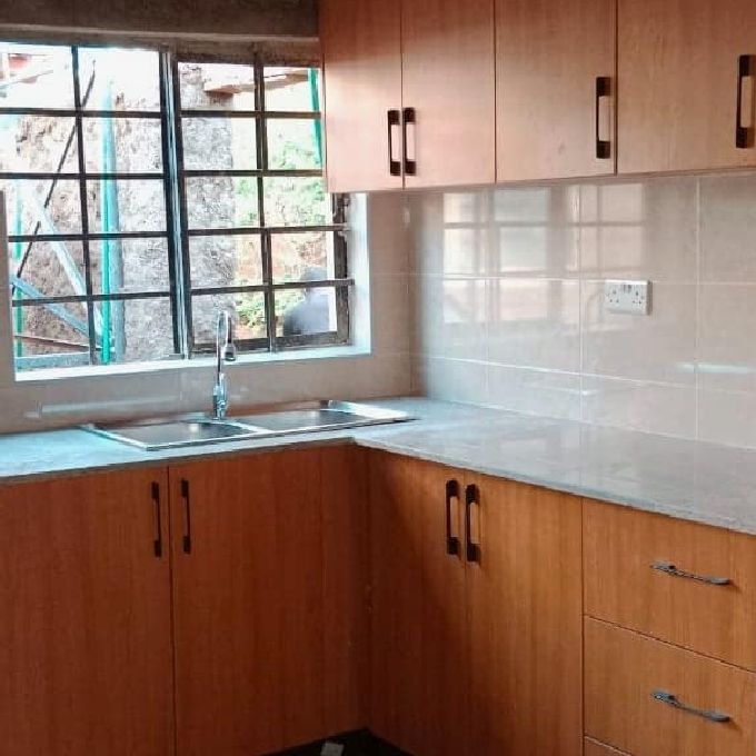 Peach Wooden Kitchen Cabinet Installation Project in Kitale