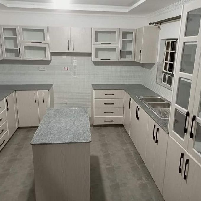 A Project in Embu Setting Up Laminated White MDF Kitchen Cabinets