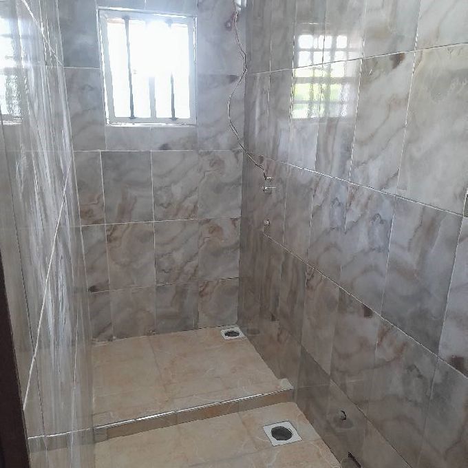 Installation of Porcelain Tiles for a Home Bathroom in Kiserian